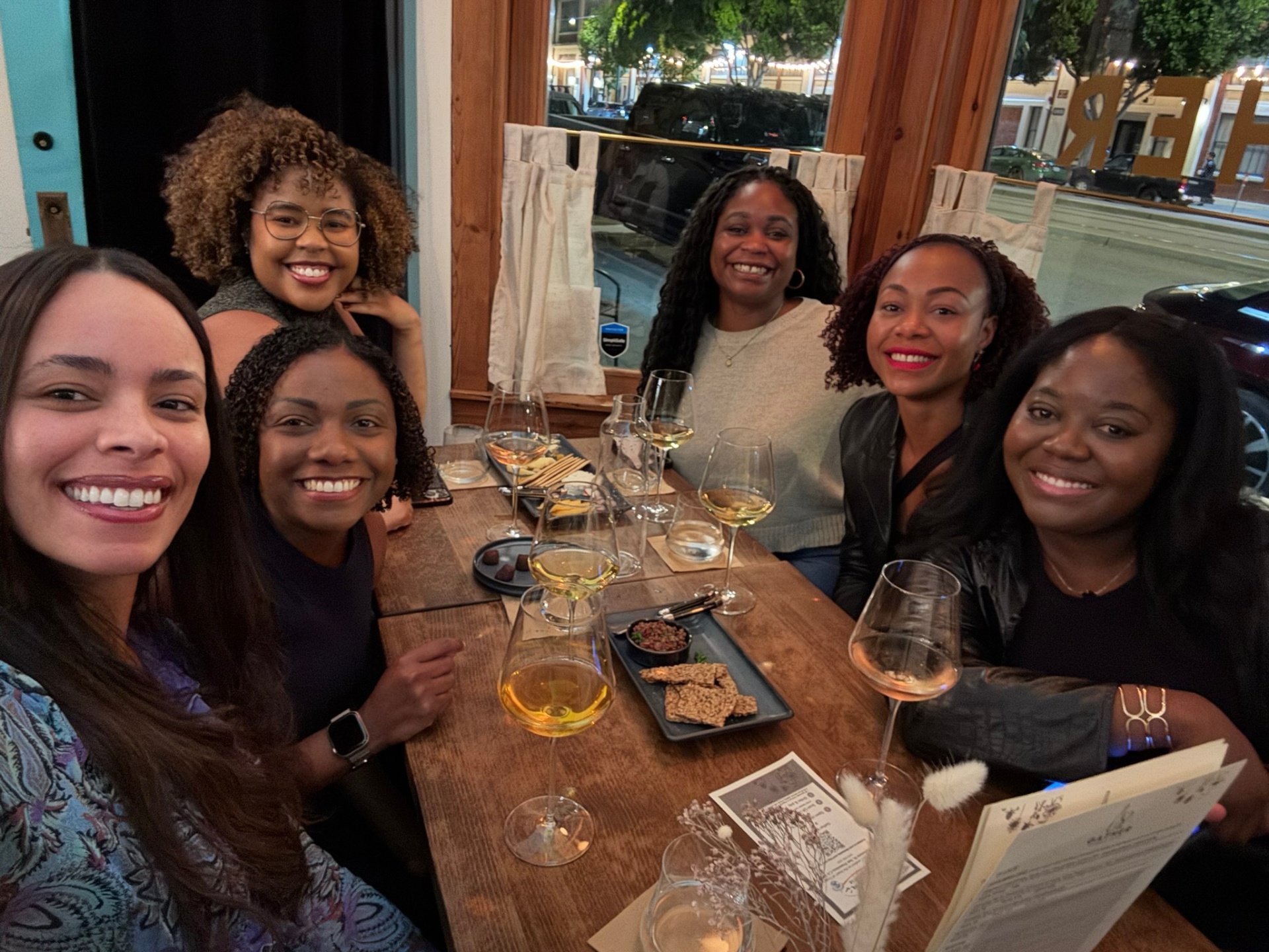 A softly lit dinner gathering with wine and conversation